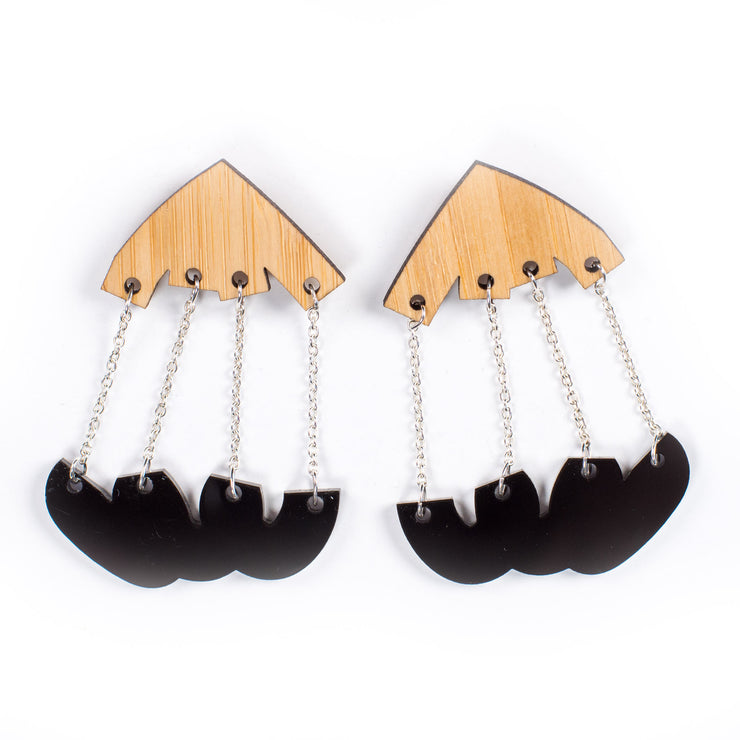 black and wood dangle earrings over white