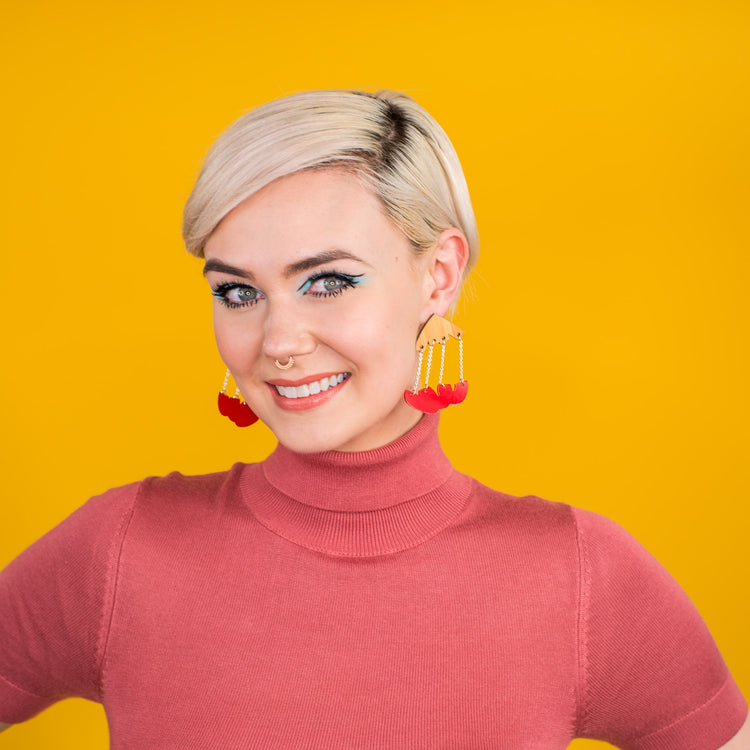 wood and red dangle earrings on model