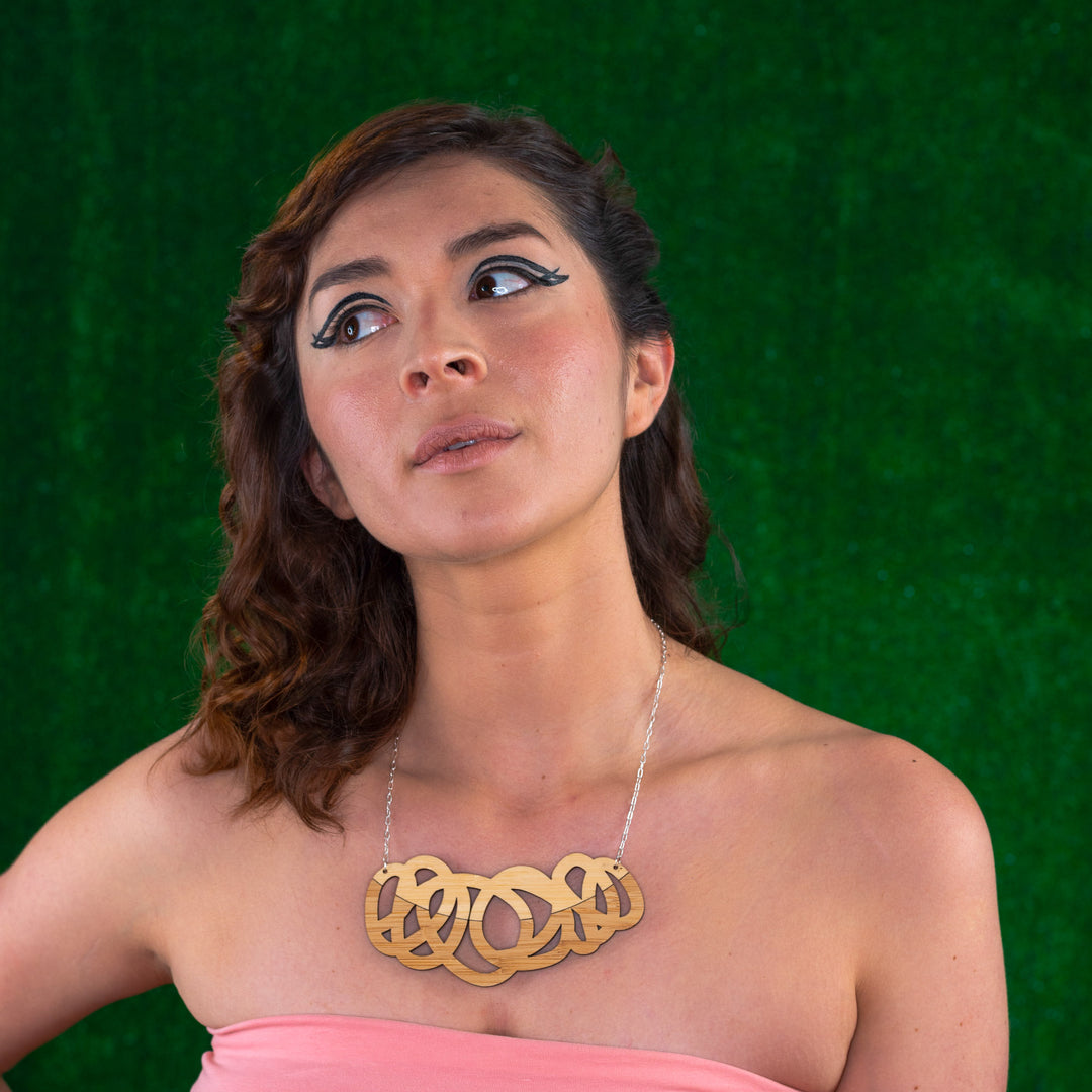 Chunky two tone wood statement necklace shown on model