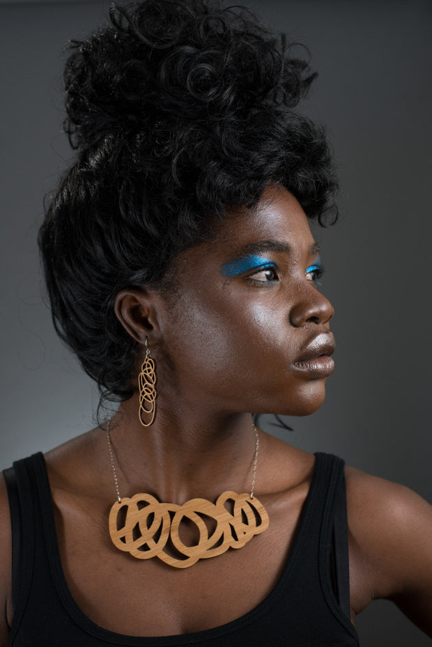 Chunky wood statement necklace shown on model