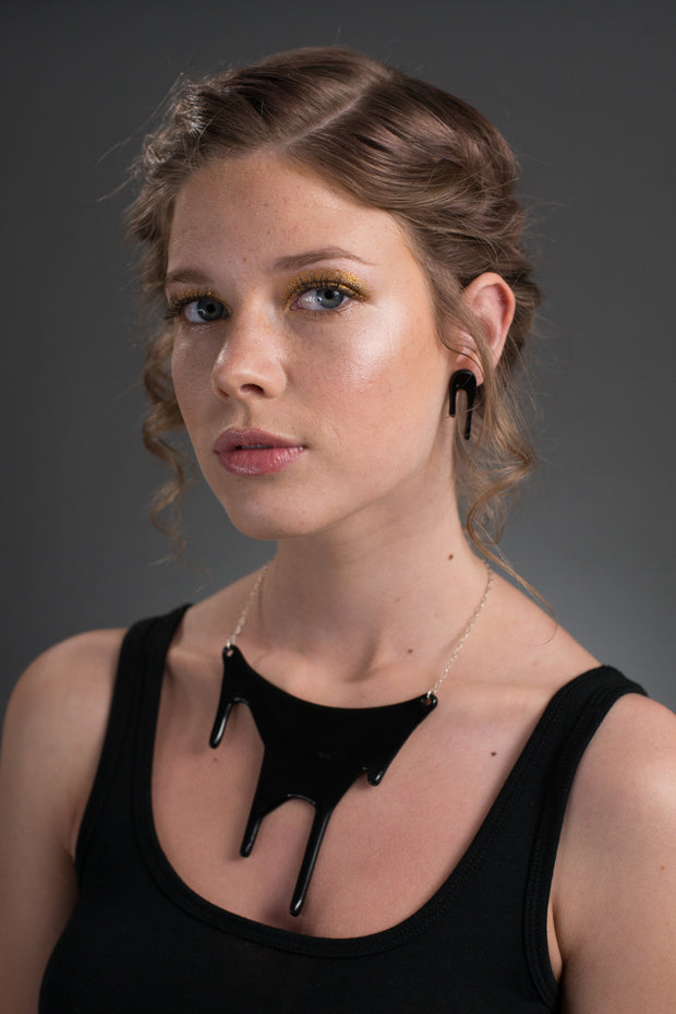 black bib necklace on model