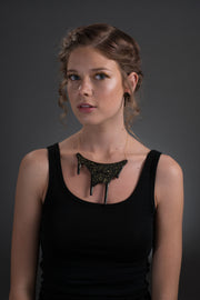 black gold statement necklace on model