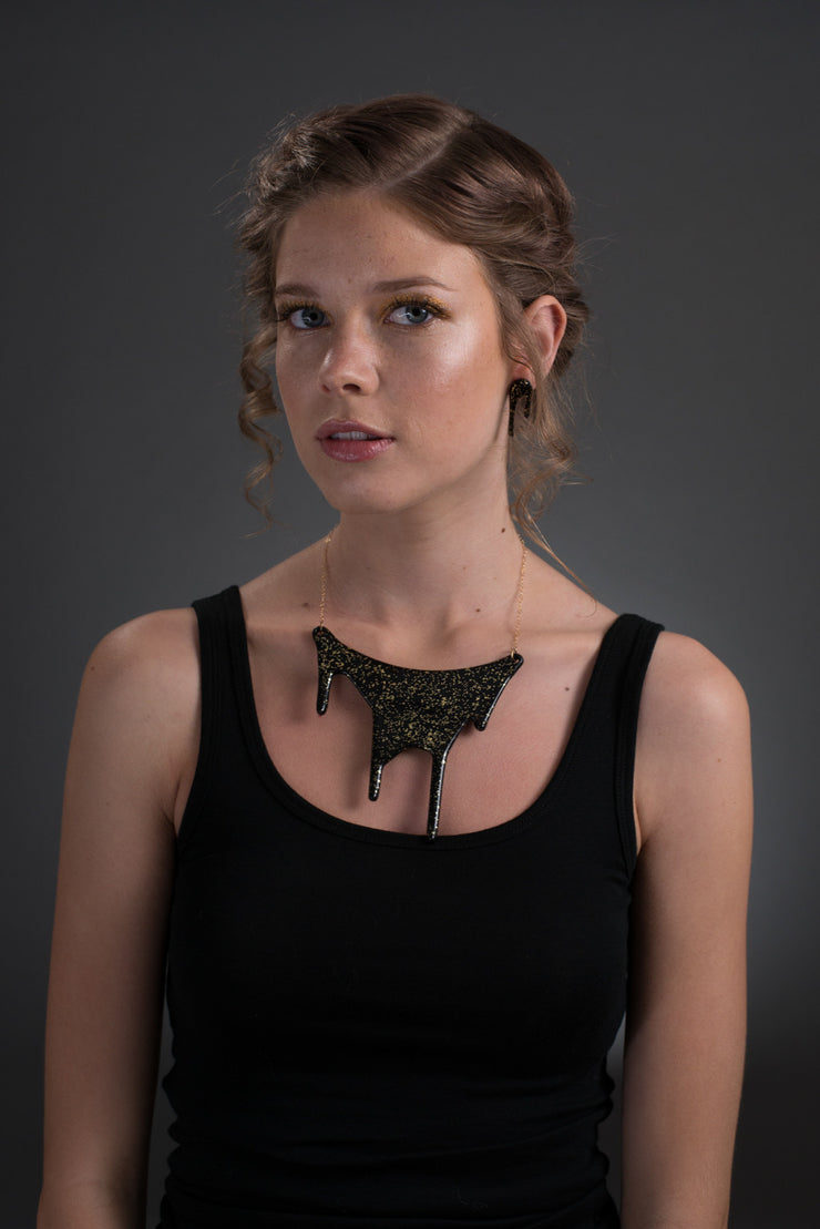 black gold statement necklace on model