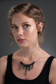 black and silver glitter necklace on model