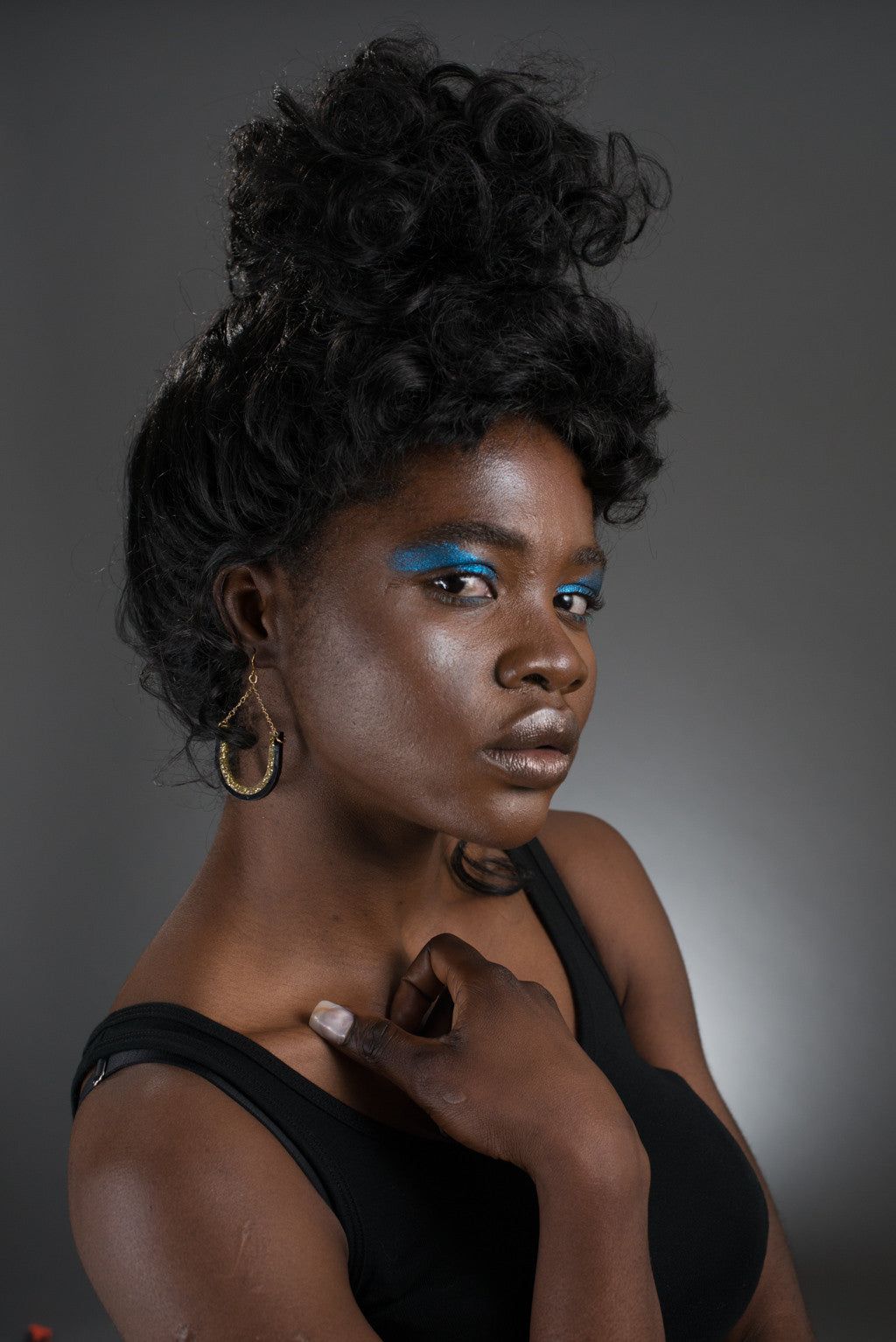 black and gold dangle earrings on model