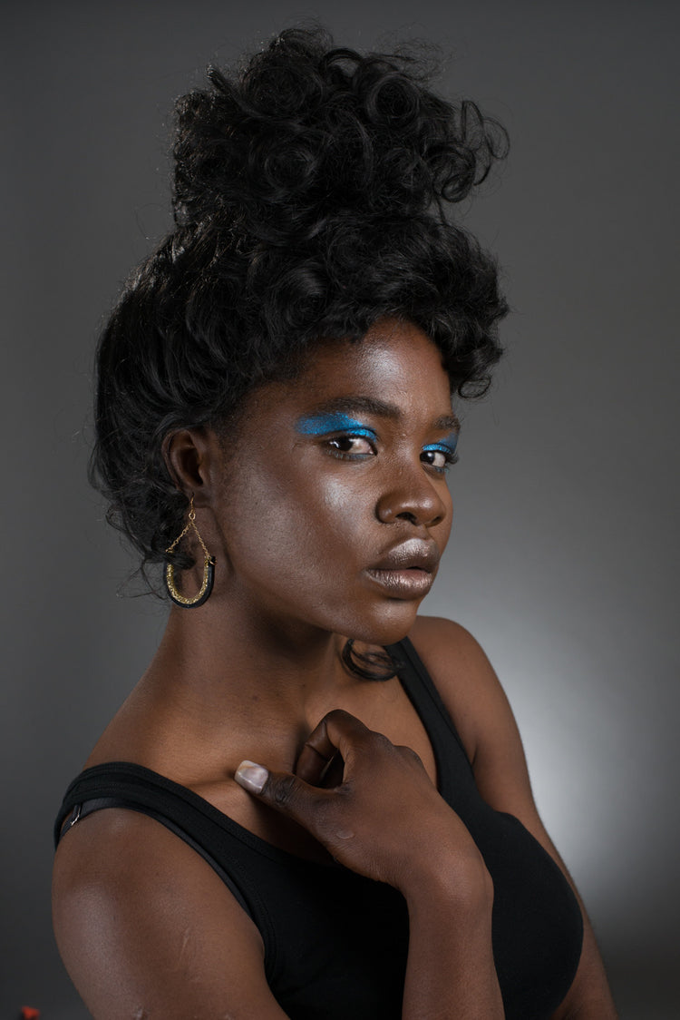 black and gold dangle earrings on model
