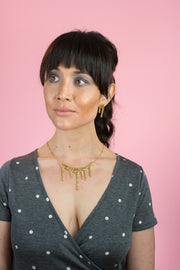 sparkly gold necklace on model