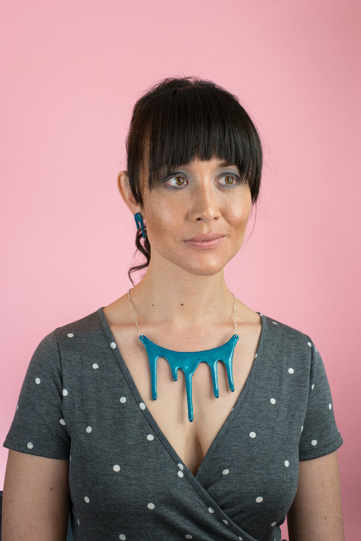 dripping blue statement necklace on model