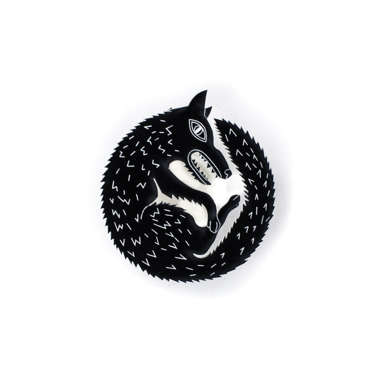 black wolf pin on white background