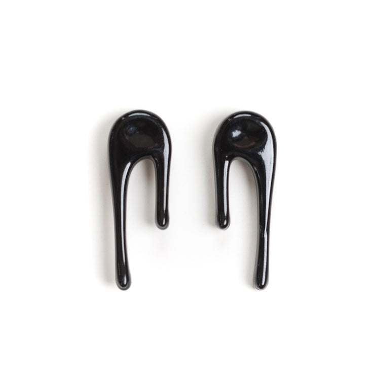 black stud earrings on white
