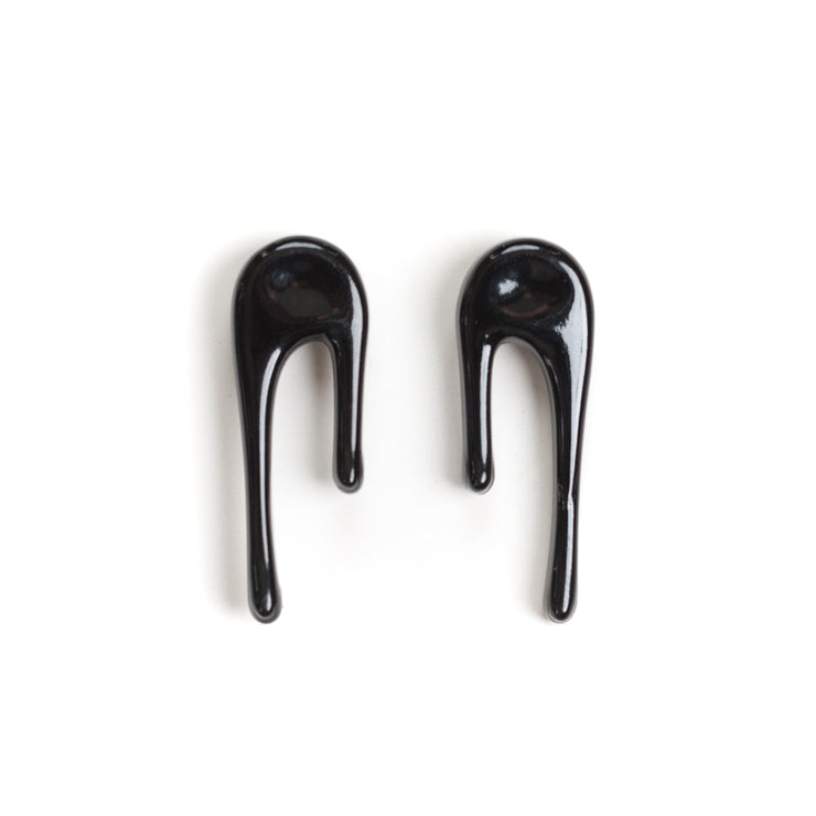 black stud earrings on white