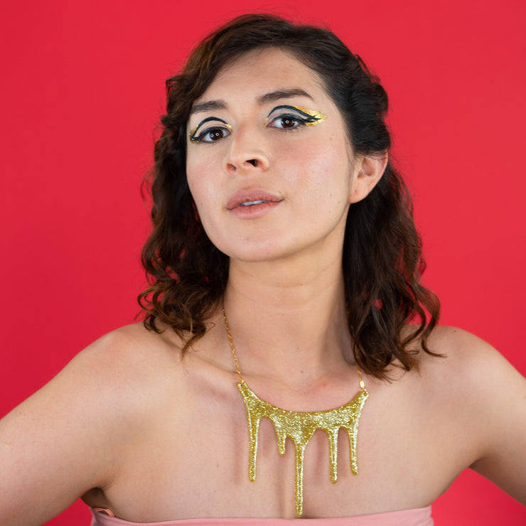 drip gold statement necklace on model