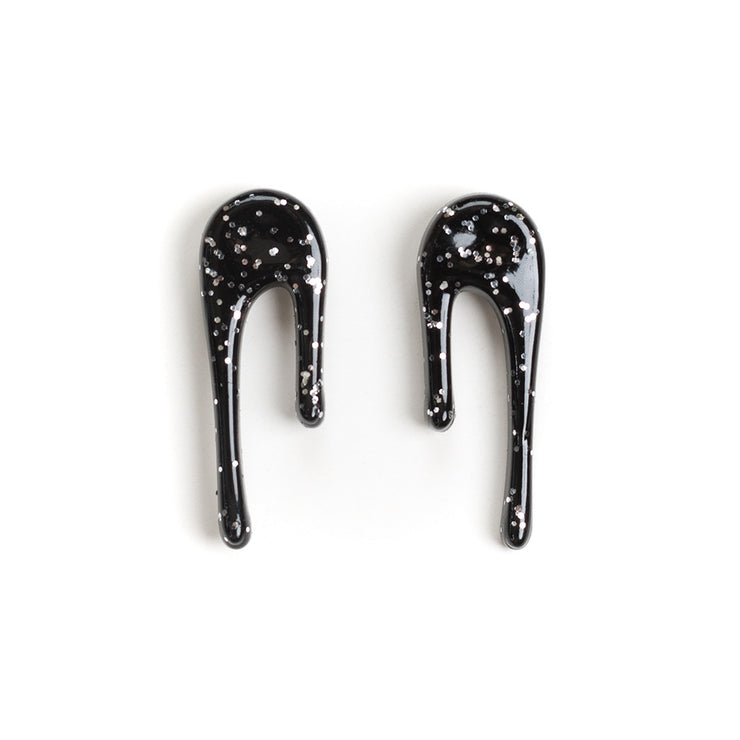 black and silver drop earrings over white
