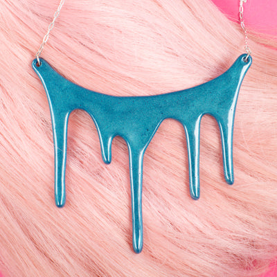 melt shimmering blue statement necklace  over pink