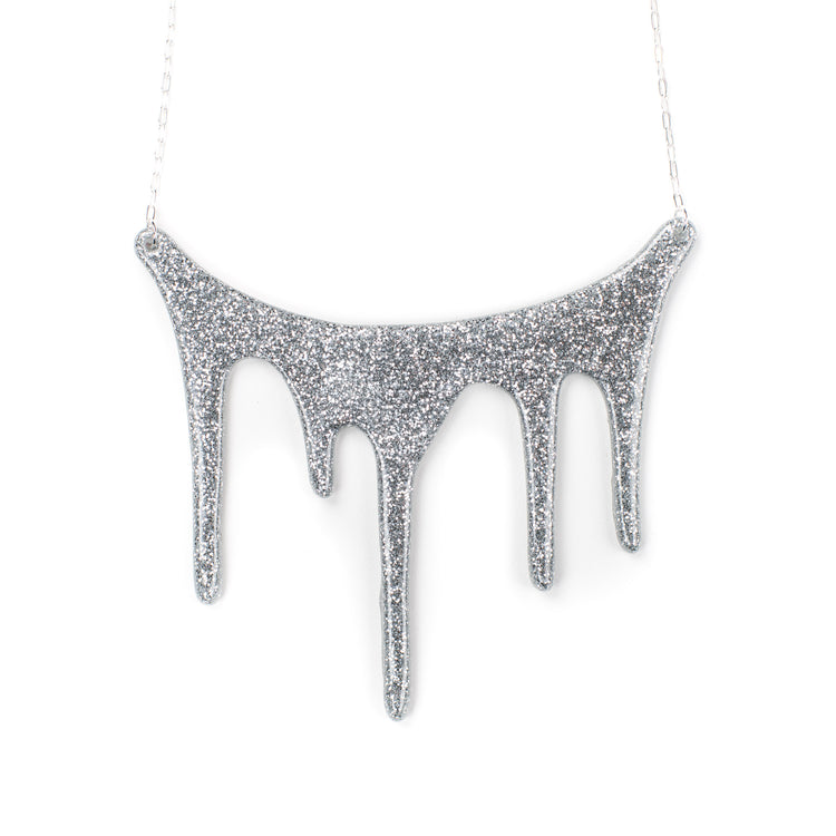 drip silver statement necklace over white