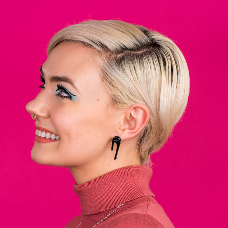 black stud earrings on model