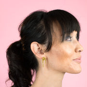 glittery gold stud earrings on model