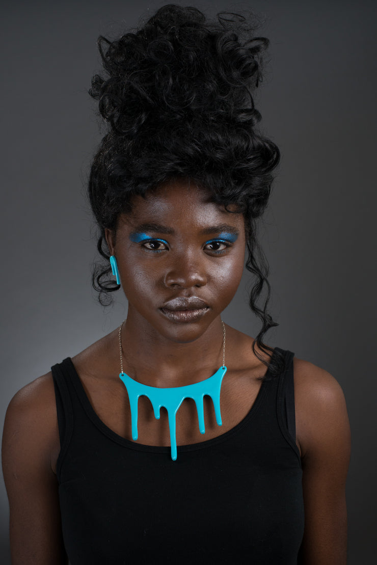 Drip blue statement necklace on model