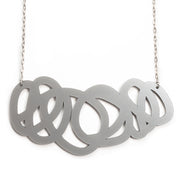 Chunky silver statement necklace on on white background
