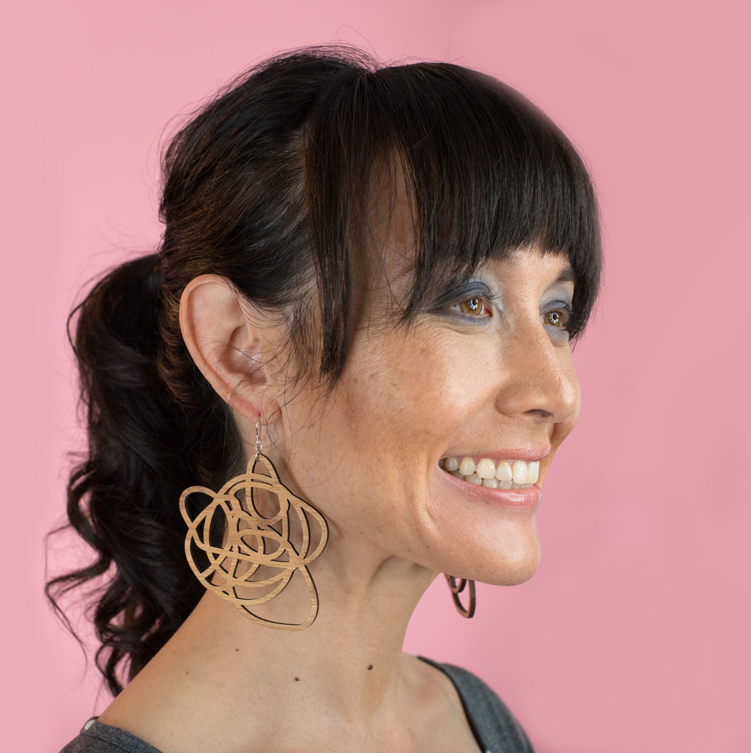 wood statement earrings on model