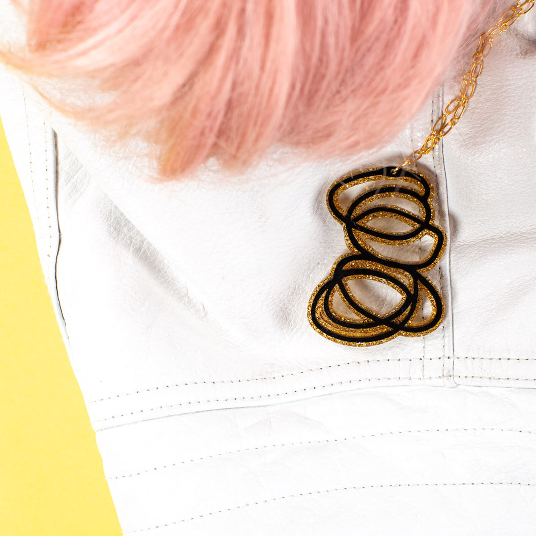 Janus Black and Gold Glitter Pendant Necklace