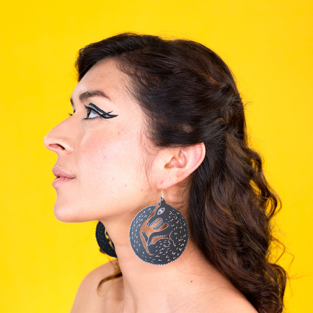large black wolf earrings on model
