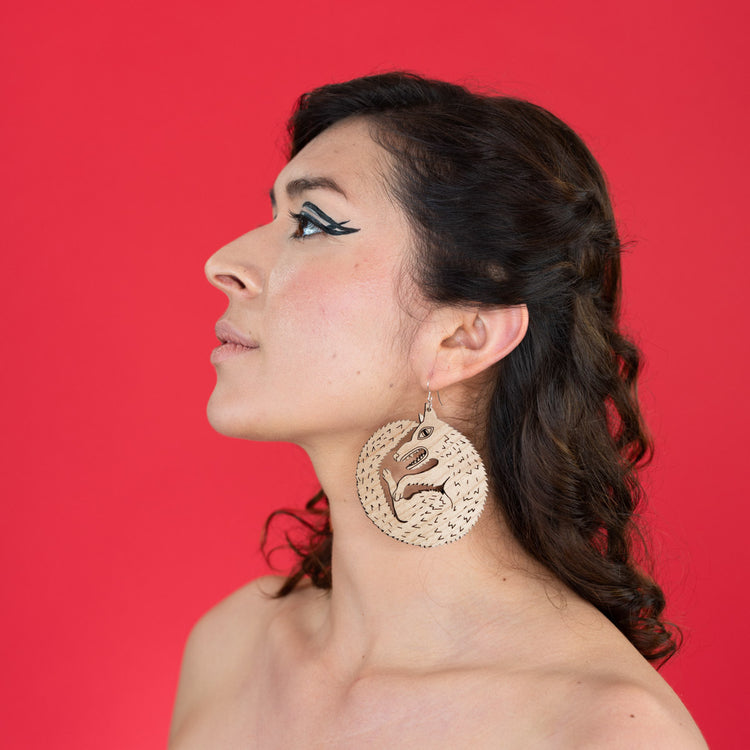 large wood wolf earrings on model