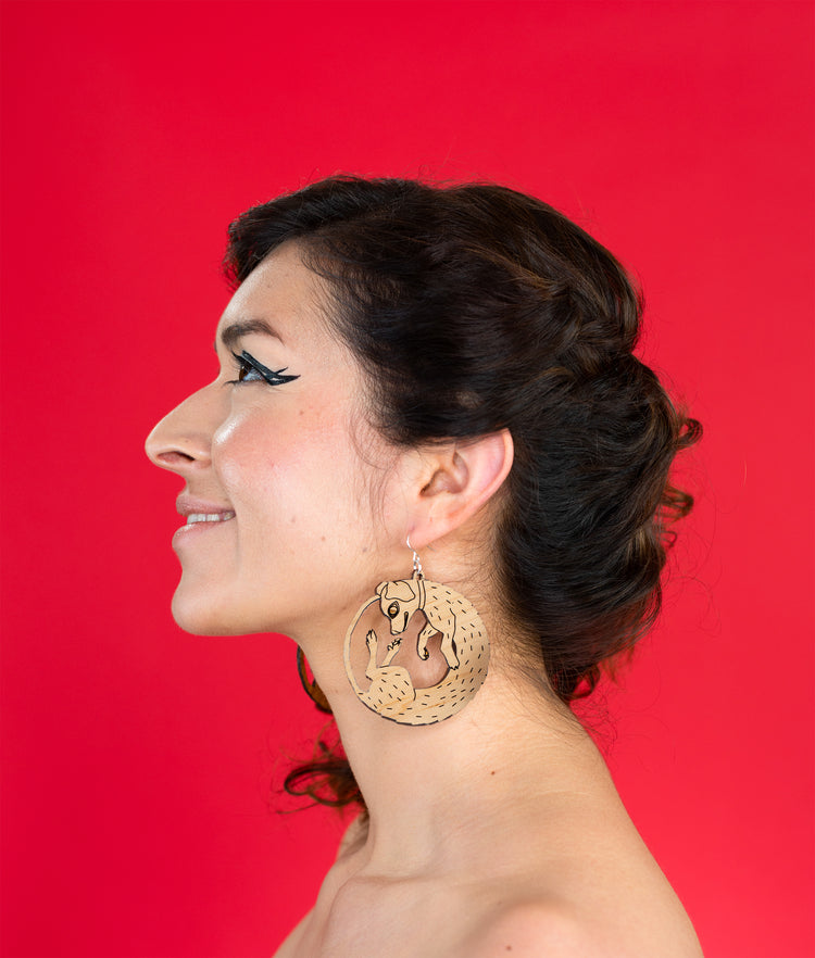 large wood dog earrings on model