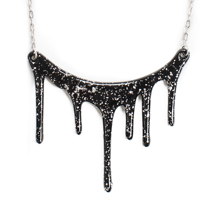 black and silver glitter resin necklace over white