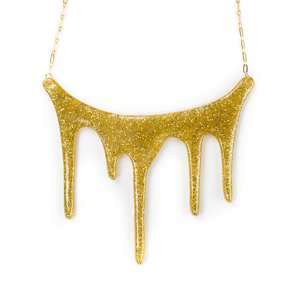 gold statement necklace over white