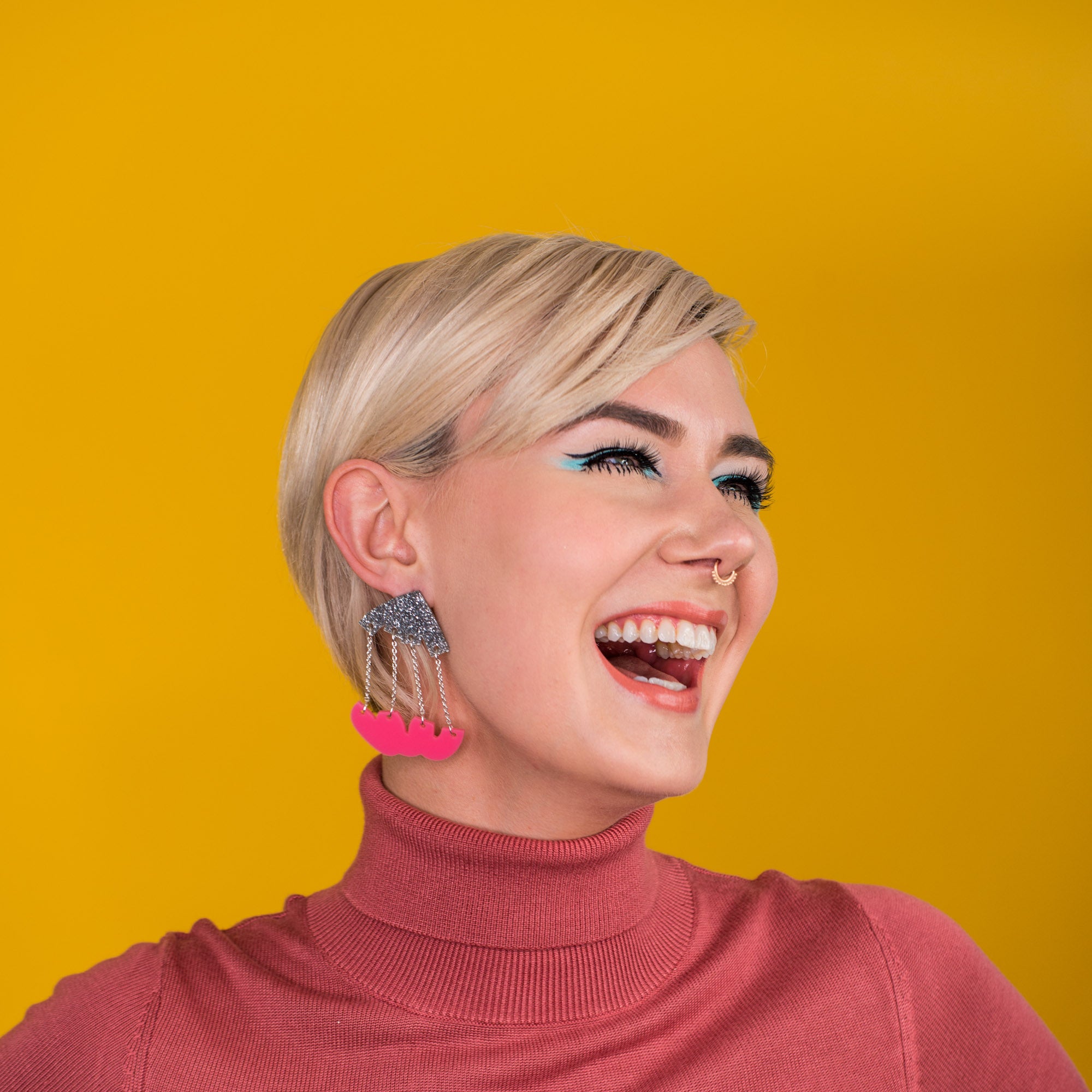 silver and pink dangle earrings on model