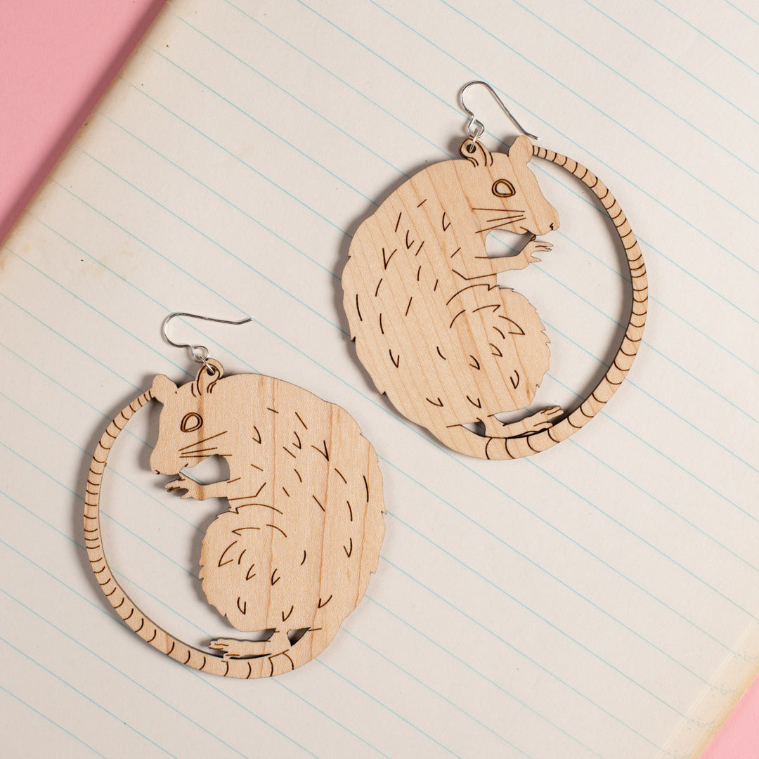 Large Wood Rat Earrings on notebook