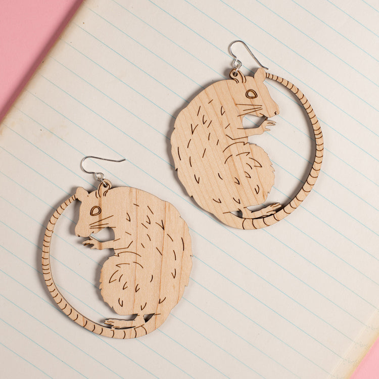 Large Wood Rat Earrings on notebook