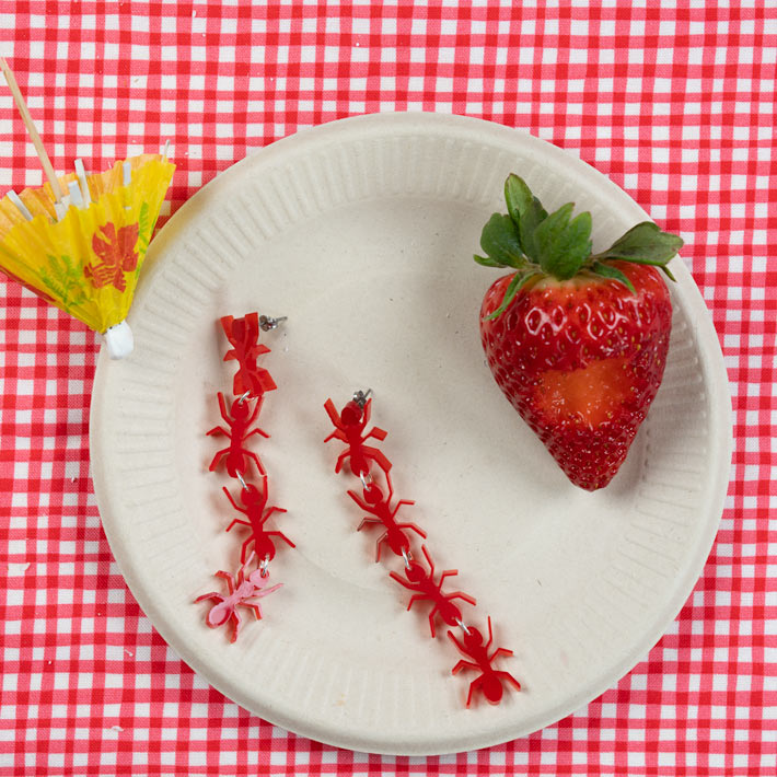 red ant earrings pictured at a picnic