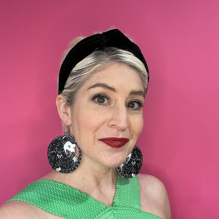 Model wearing large possum earrings