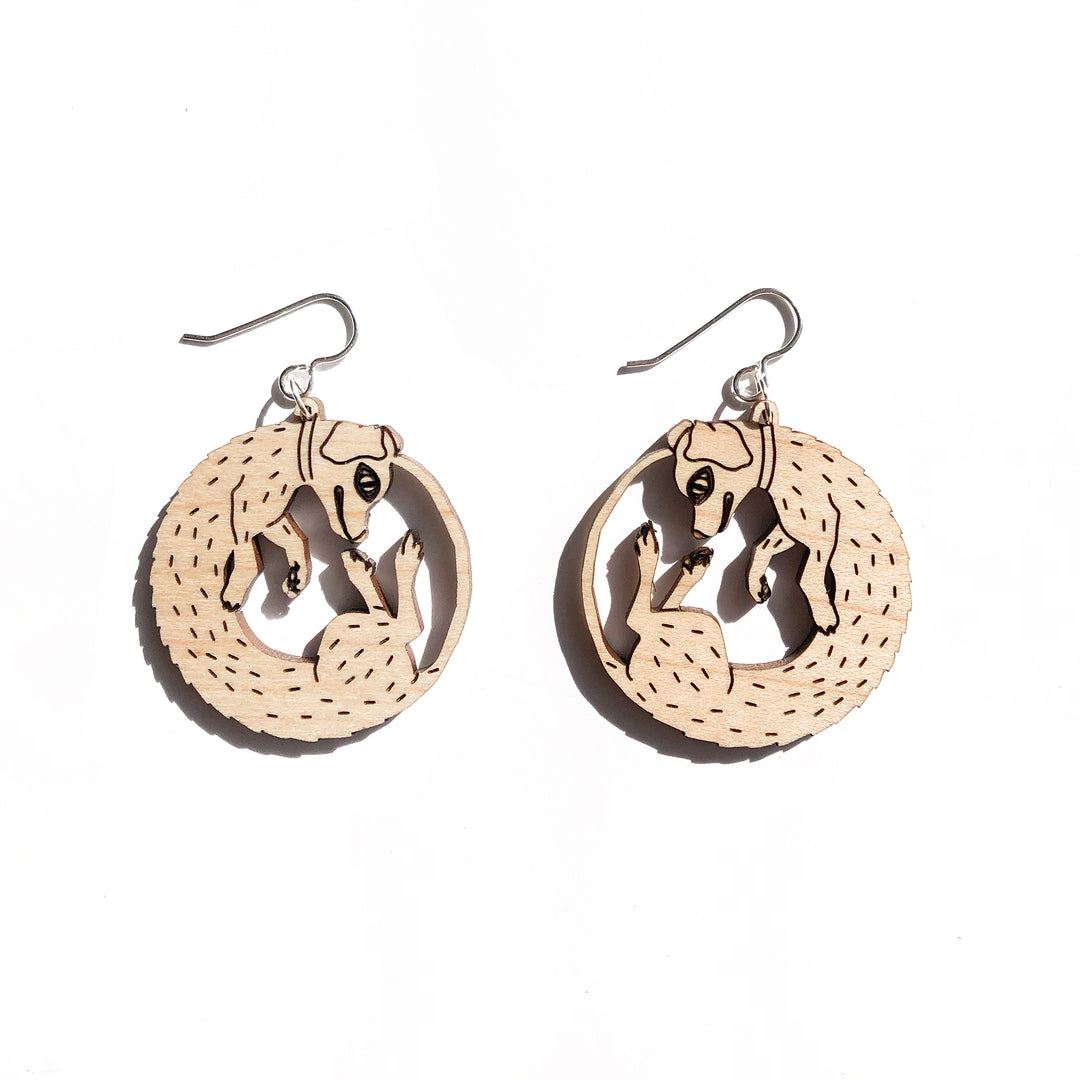 small wood dog earrings on white background