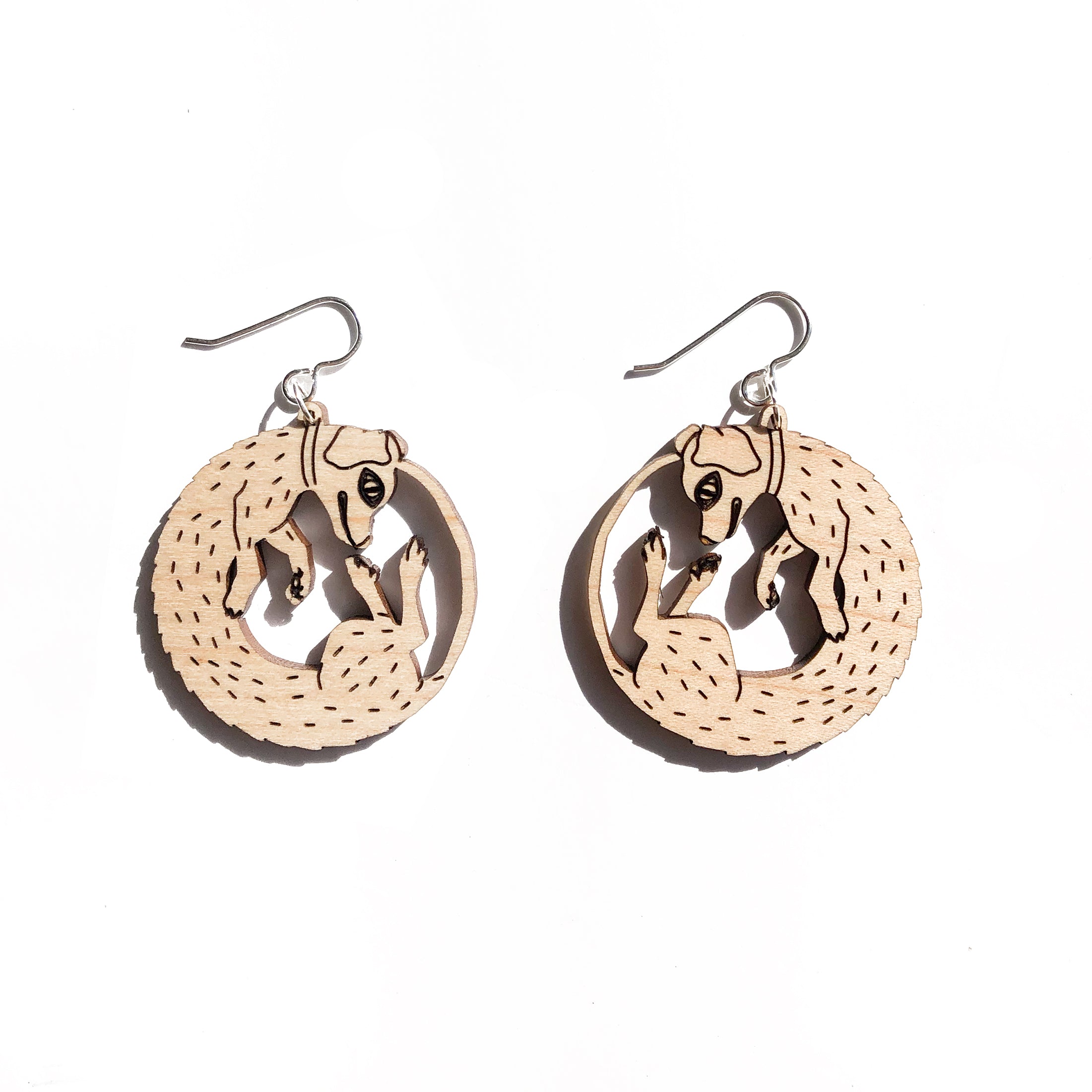 small wood dog earrings on white background