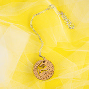 wood wolf necklace on yellow background