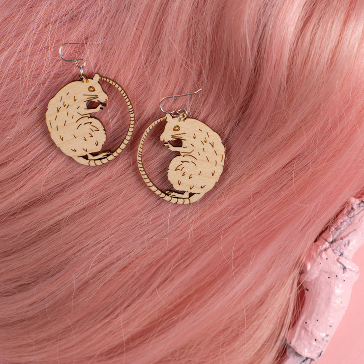 small wood rat earrings on pink wig