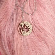 wood dog necklace on pink wig
