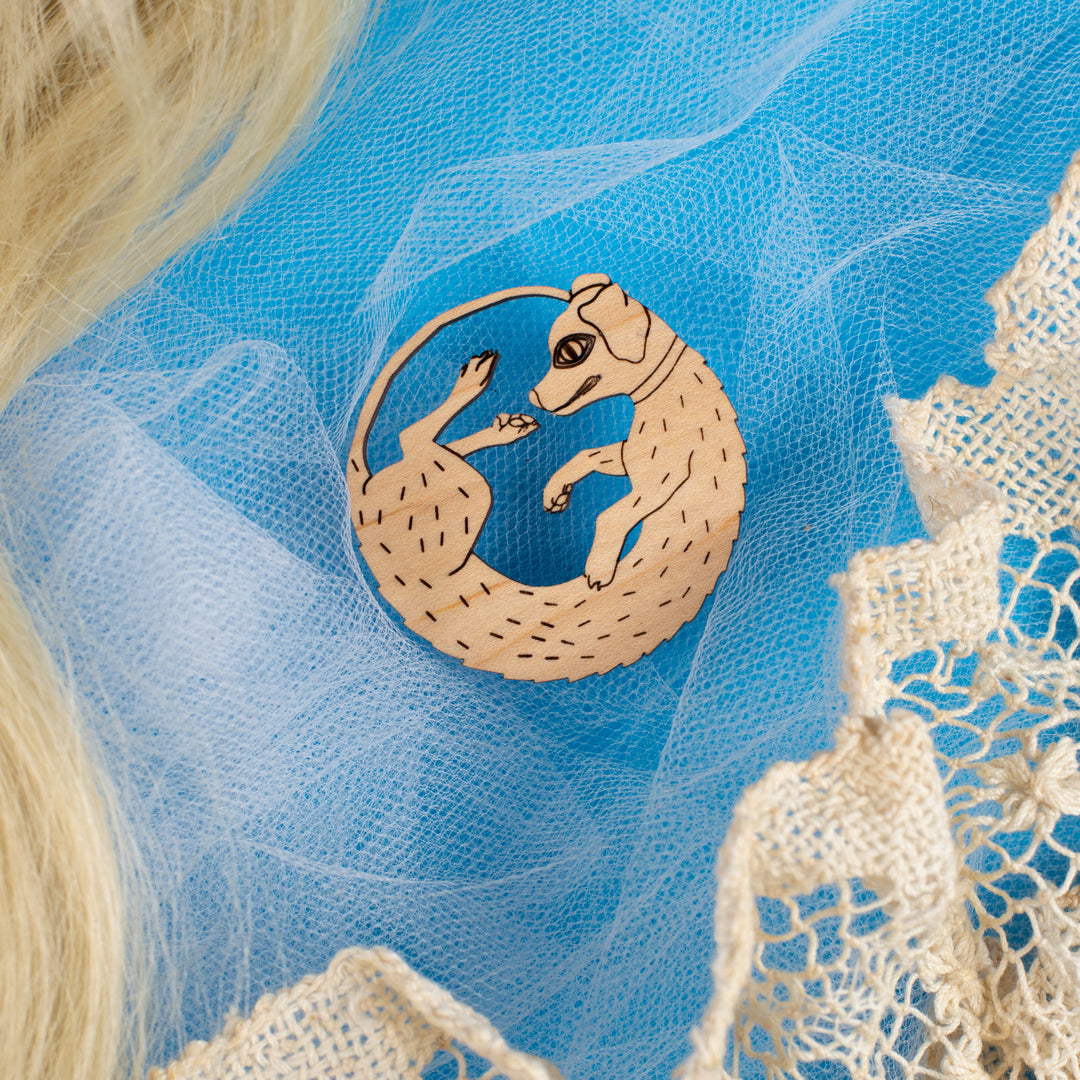 wood dog pin on blue background