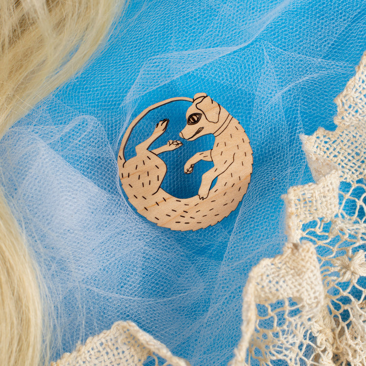 wood dog pin on blue background