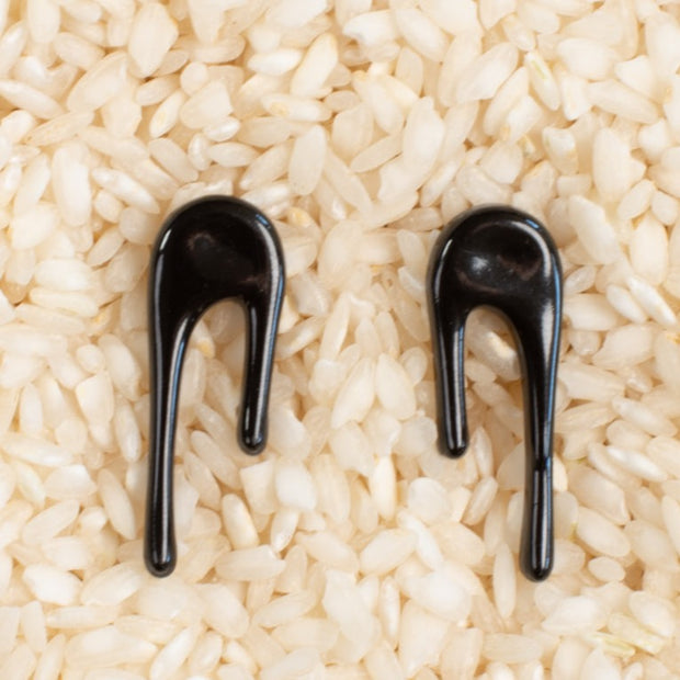 black stud earrings on rice