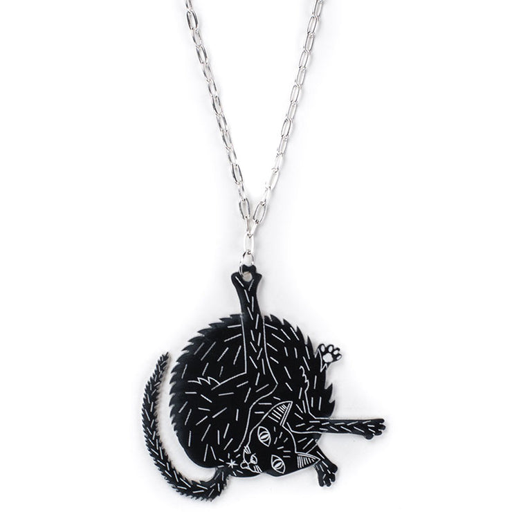 black cat necklace over white background