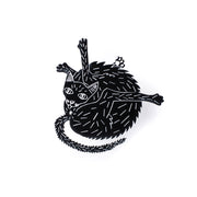 black cat pin over white background