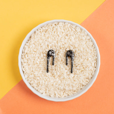 black and silver stud earrings in rice