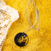 black dog necklace on yellow background