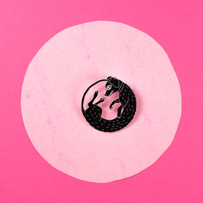 black dog pin on pink background