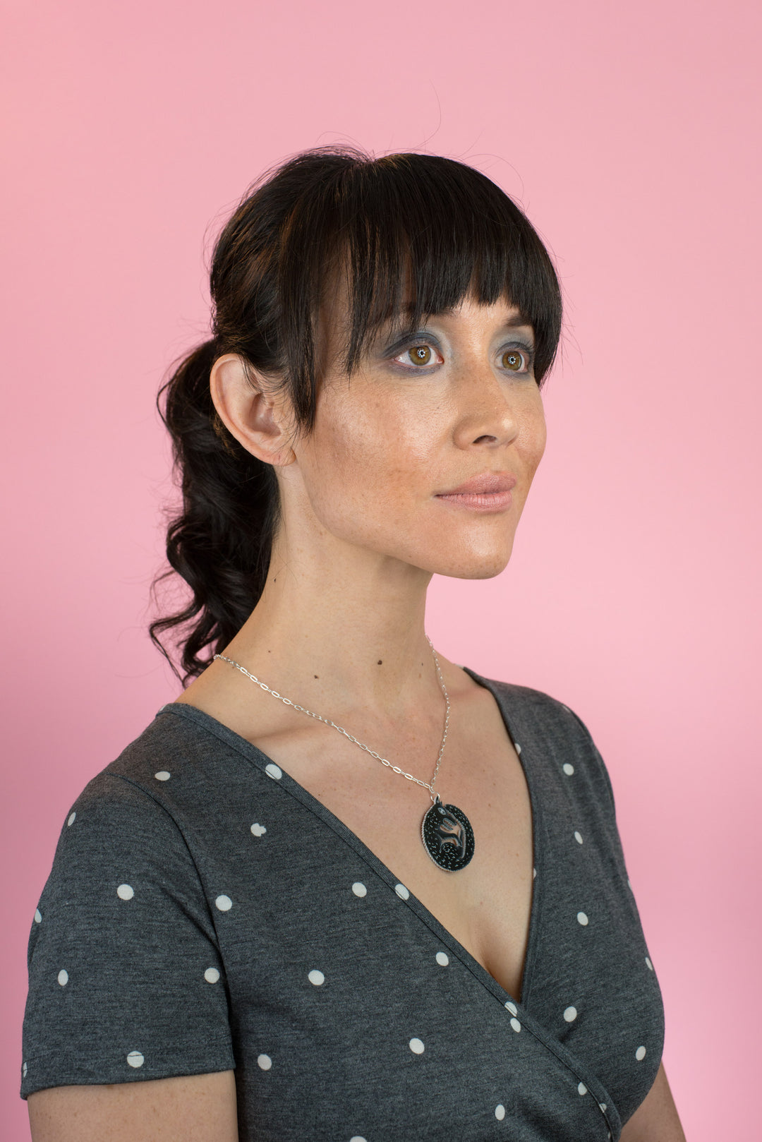 black wolf necklace on model