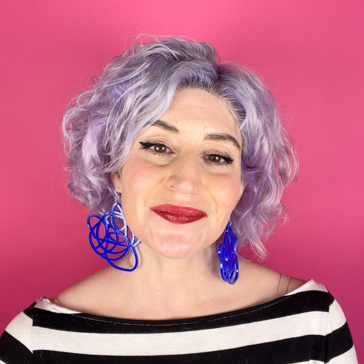 blue earrings modeled on white woman with purple hair